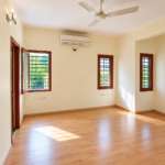 RT Nagar independent house interior with spacious rooms, wooden flooring and large windows.