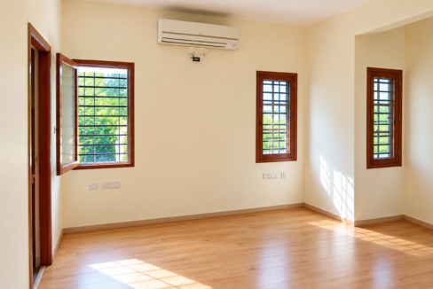 RT Nagar independent house interior with spacious rooms, wooden flooring and large windows.
