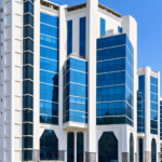 Embassy Heights commercial office building with modern blue glass facade.