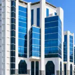 Embassy Heights commercial office building with modern blue glass facade.