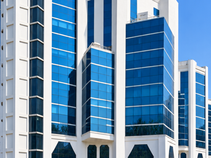Embassy Heights commercial office building with modern blue glass facade.
