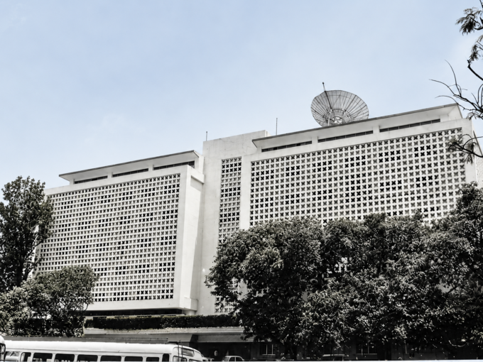 Sona Towers commercial building with a white patterned facade and surrounding trees.